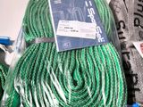 a green rope and a pair of scissors sitting on a table