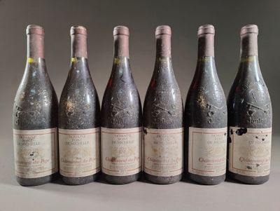 six bottles of wine are lined up in a row on a table