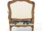 a small chair with a checkered upholstered seat