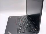 a black laptop with a red button on the keyboard