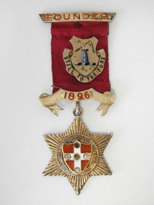 an image of a red and gold medal with a star on it