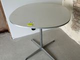 a white table with a yellow sticker on it