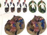 several figurines of men in uniforms are displayed in a display case