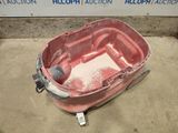 a red bucket that is sitting on the ground