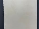 blank white paper hanging on a metal bar on a dark background