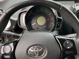dashboard view of a car with a steering wheel and dashboard controls