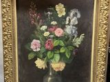 painting of a vase of flowers in a gold frame on a table