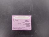 a purple sticker on the back of a black chair