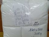 two white pillows are wrapped in plastic bags on top of a cardboard box