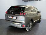 the rear end of a silver suv parked in a garage