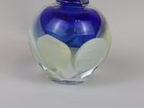 a glass vase with a blue and white design on it