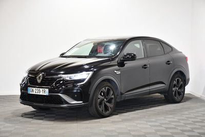 a black car parked in a room with a checkered floor