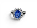 a blue sapphire and diamond ring on a white background