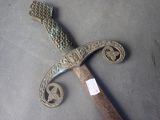 a very old looking dagger with a very long handle