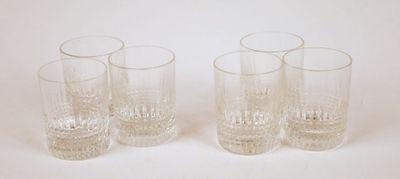 four glasses are lined up in a row on a white surface