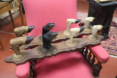 a pink chair that has a bunch of birds on it