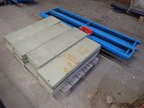 a pile of wood sitting on a pallet in a warehouse