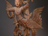 an image of a statue of a person holding a bird
