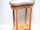 a small wooden table with a mirror on top of it