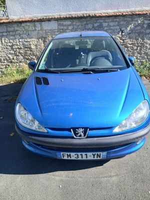 a blue car that is parked in the parking lot