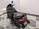 a motorcycle that is parked in a room with a checkered floor