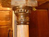 a marble column in a room with a wooden ceiling