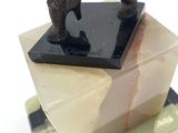 statue of a man on a marble block with his foot on top of it