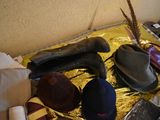a pile of hats and other items sitting on a table