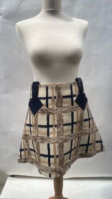 beige and black checkered skirt with blue bow accent