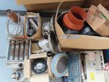 a pile of assorted items in a box on the floor