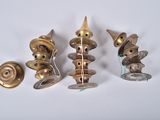 several brass candles are lined up on a white surface