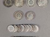 several coins are arranged in a row on a gray surface