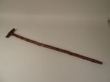 a wooden stick with a hammer on top of it