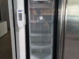a refrigerator with a door open in a kitchen
