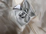 a close up of a white shirt with a black label on it