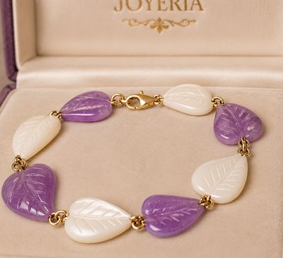 purple and white leaf bracelet in a box with a gold clasp