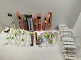many different types of toothbrushes and toothpaste on the table