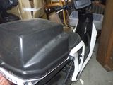 a motor scooter that is parked in a garage