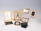 a lot of picture frames that are sitting on a table
