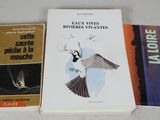 three books sitting on top of a white table next to each other