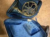 a blue case with a brass instrument inside of it