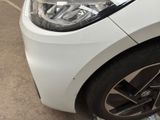 a close up of a car ' s headlight on a parking lot