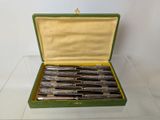 a green case with six different types of pens in it
