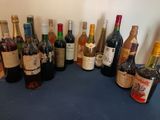 bottles of wine are lined up on a blue counter top