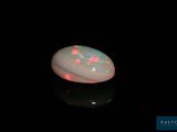a white oplite with pink and green stars on it