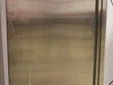 a stainless steel refrigerator in a room with a white wall