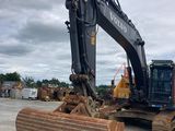 the back end of a bulldozer sitting on top of a pile of wood