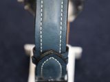 a close up of a watch with a leather band