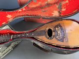 a guitar inside of a case on a table