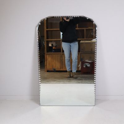 a woman taking a picture of herself in a mirror